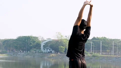 Asia Man Stretching In The Morning at Garden Lake View After Running Workout. Stock Footage