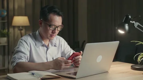 Asia Man Use Smartphone While Working From Home At Living Room At Night Stock Footage 154917610