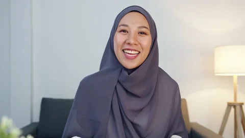 Asia muslim lady using computer laptop talk to colleague in video call meeting. Stock Footage 142237707