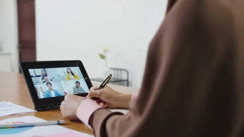 Asia muslim lady using tablet talk to colleague about plan by video call. Video stock 141893851