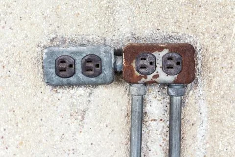 Asia plug socket on brick wall background. Risk of danger Stock Photos