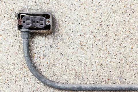 Asia plug socket on brick wall background. Risk of danger Stock Photos