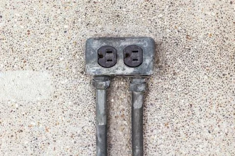 Asia plug socket on brick wall background. Risk of danger Stock Photos