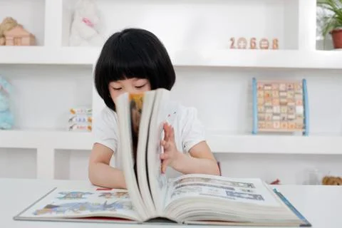 Asia Turn the book Alone Learning Oriental Asians Education Knowledge Read a Stock Photos