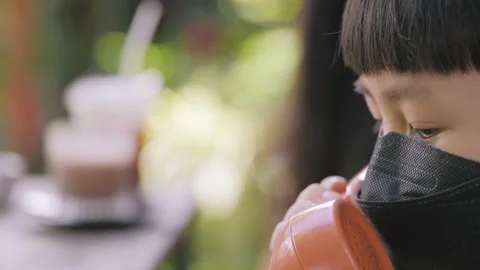 Asian 6 years old kid with face mask talking on the call. Stock Footage 220244745