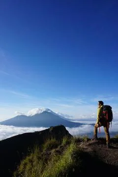 Asian Adventure, Man Model on Mountain Summit, Carrying Hiking Gear under B.. Stock Photos