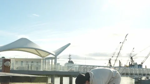 Asian American Runner Pre-Run Stretch — Alameda Marina Park Trail, California Stock Footage 330022843