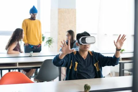 Asian app developer using virtual reality simulator Stock Photos