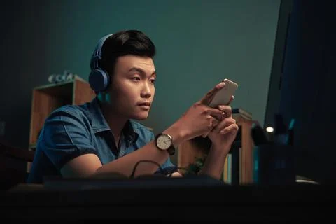 Asian App Developer Working At Night Stock Photos