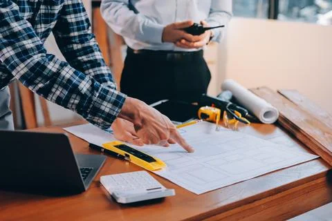 Asian architect and engineer team checking architectural house model using .. Stock Photos