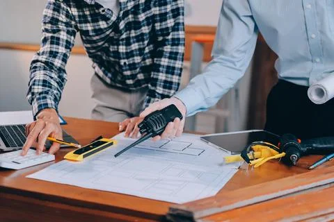 Asian architect and engineer team checking architectural house model using .. Stock Photos