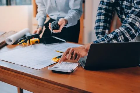 Asian architect and engineer team checking architectural house model using .. Stock Photos