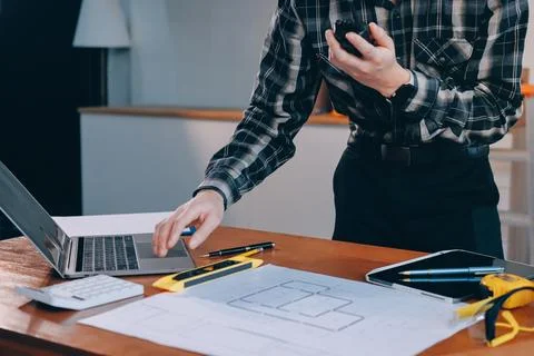 Asian architect and engineer team checking architectural house model using .. Stock Photos