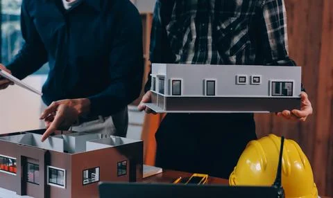 Asian architect and engineer team checking architectural house model using .. Stock Photos