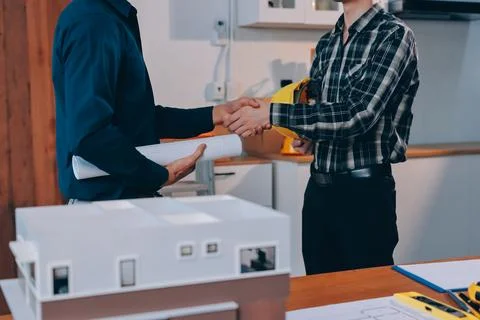 Asian architect and engineer team checking architectural house model using .. Stock Photos