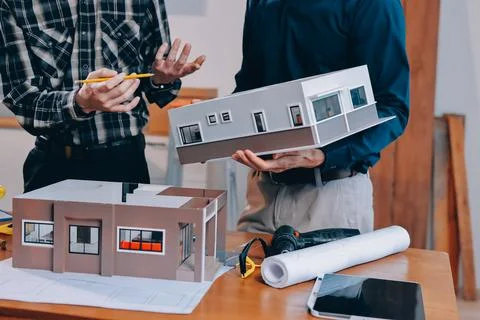 Asian architect and engineer team checking architectural house model using .. Stock Photos