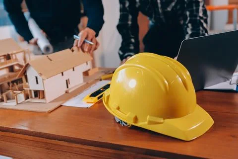 Asian architect and engineer team checking architectural house model using .. Stock Photos