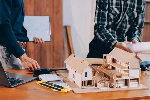 Asian architect and engineer team checking architectural house model using .. Stock Photos
