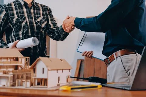 Asian architect and engineer team checking architectural house model using .. Stock Photos