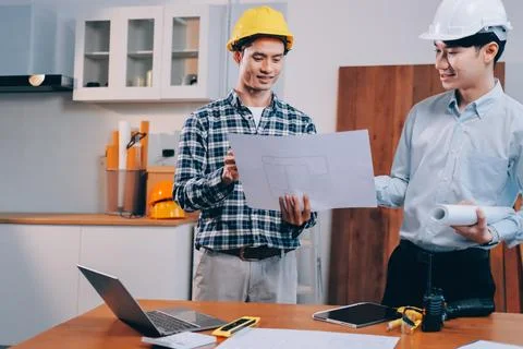 Asian architect and engineer team checking architectural house model using .. Stock Photos