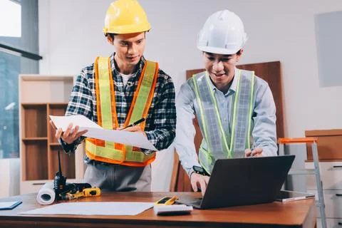 Asian architect and engineer team checking architectural house model using .. Stock Photos