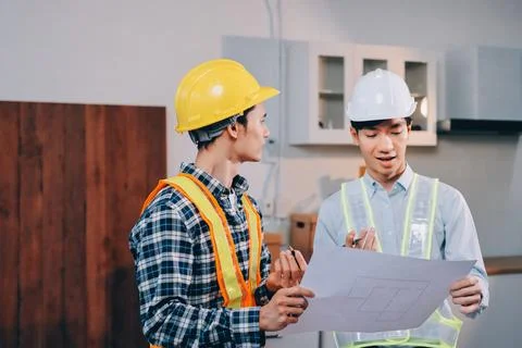 Asian architect and engineer team checking architectural house model using .. Stock Photos