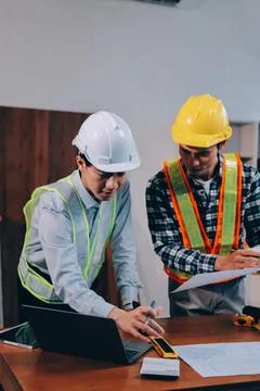 Asian architect and engineer team checking architectural house model using .. Stock Photos
