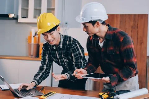 Asian architect and engineer team checking architectural house model using .. Stock Photos