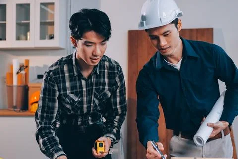 Asian architect and engineer team checking architectural house model using .. Stock Photos