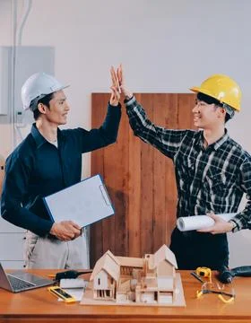 Asian architect and engineer team checking architectural house model using .. Stock Photos