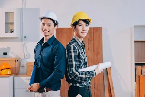 Asian architect and engineer team checking architectural house model using .. Stock Photos