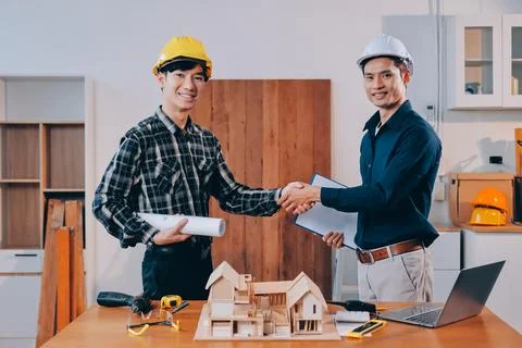 Asian architect and engineer team checking architectural house model using .. Stock Photos