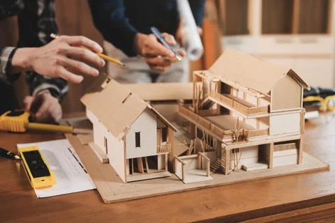 Asian architect and engineer team checking architectural house model using .. Stock Photos