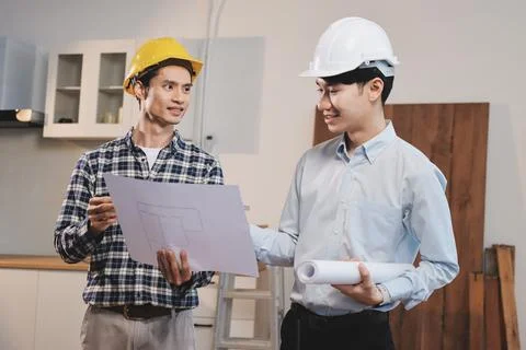 Asian architect and engineer team checking architectural house model using .. Stock Photos