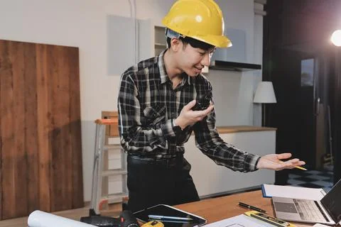 Asian architect and engineer team checking architectural house model using .. Stock Photos