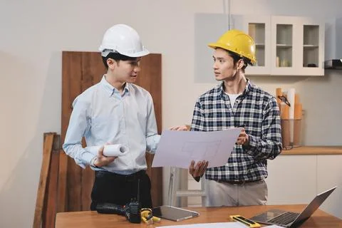 Asian architect and engineer team checking architectural house model using .. Stock Photos
