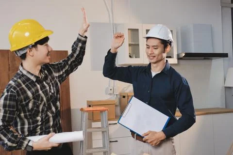 Asian architect and engineer team checking architectural house model using .. Stock Photos