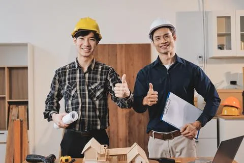 Asian architect and engineer team checking architectural house model using .. Stock Photos