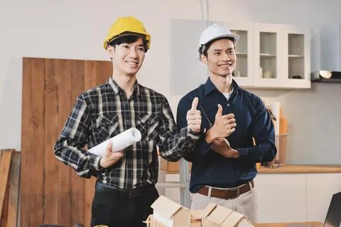 Asian architect and engineer team checking architectural house model using .. Stock Photos