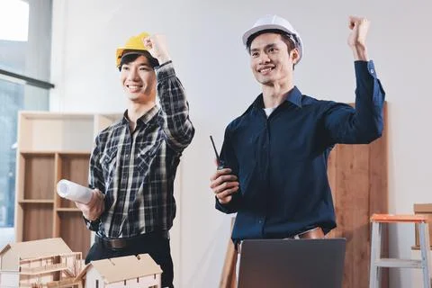 Asian architect and engineer team checking architectural house model using .. Stock Photos