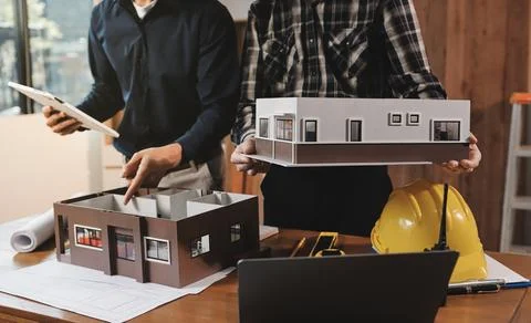 Asian architect and engineer team checking architectural house model using .. Foto stock