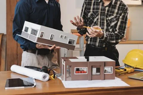 Asian architect and engineer team checking architectural house model using .. Foto stock