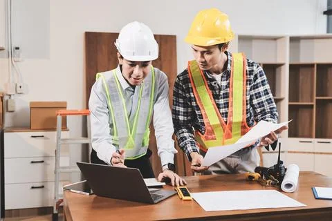 Asian architect and engineer team checking architectural house model using .. Foto stock