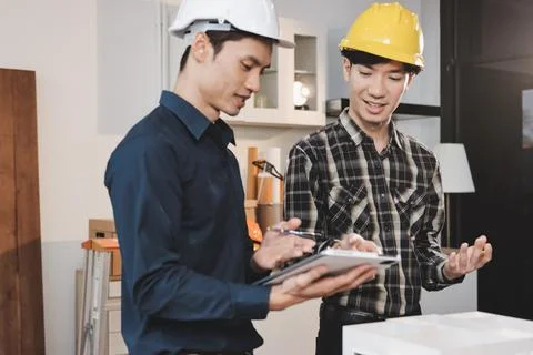 Asian architect and engineer team checking architectural house model using .. Foto stock