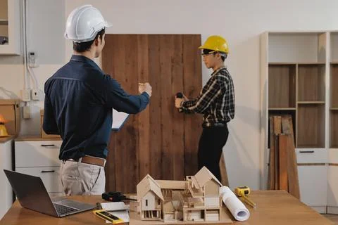 Asian architect and engineer team checking architectural house model using .. Foto stock