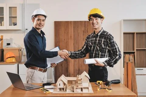 Asian architect and engineer team checking architectural house model using .. Foto stock