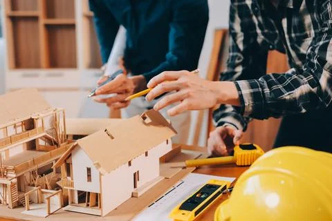 Asian architect and engineer team checking architectural house model using .. Stock Photos