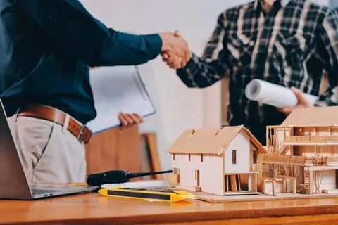 Asian architect and engineer team checking architectural house model using .. Stock Photos