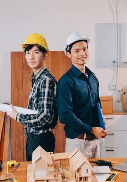 Asian architect and engineer team checking architectural house model using .. Stock Photos