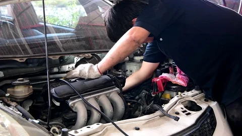 Asian auto mechanic checking and repair engine. Stock Footage 78550830